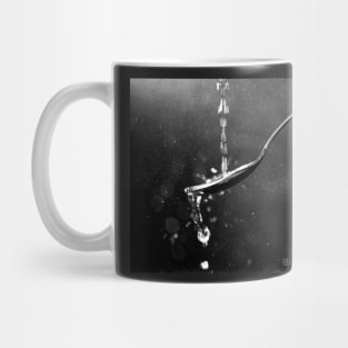 Drops of water fall on a spoon Mug